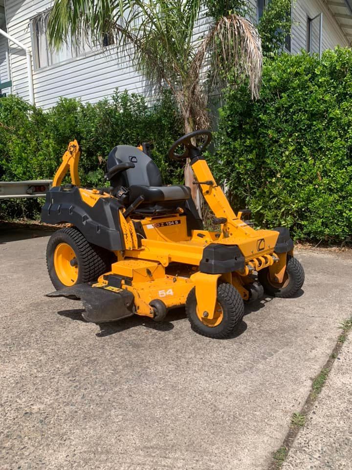 A Green Lawn Mower Is Sitting On Top Of A Lush Green Lawn — Whitsunday Mowers In Proserpine, QLD