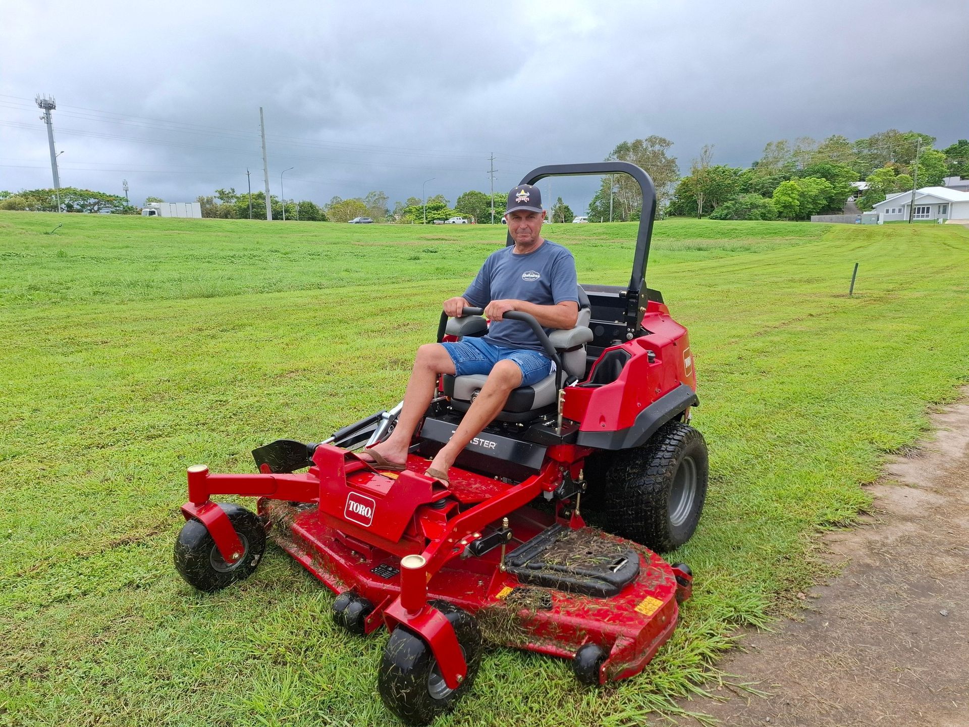 A Man Is Working On A Lawn Mower In A Garage — Whitsunday Mowers In Proserpine, QLD