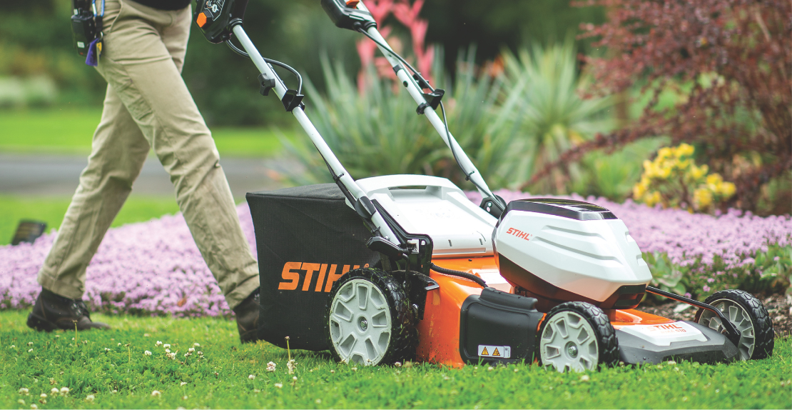 A Close Up Of A Lawn Mower Cutting Grass On A Lush Green Lawn — Whitsunday Mowers In Airlie Beach, QLD