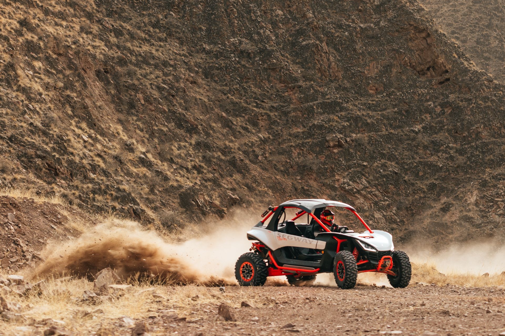White and Orange Off-Road Vehicle Kicking up Dust on A Dirt Road in A Desert Landscape — Whitsunday Mowers In Cannonvale, QLD