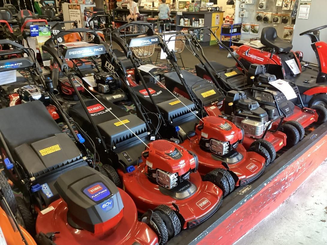 A Row Of Lawn Mowers Are Lined Up In A Store — Whitsunday Mowers In Airlie Beach, QLD