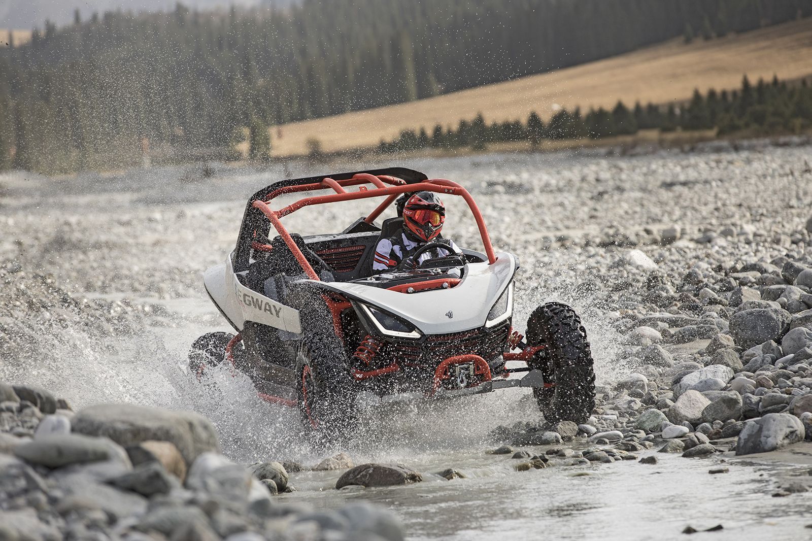 White and Red Off-Road Vehicle Splashing Through Water in Rocky Terrain — Whitsunday Mowers In Airlie Beach, QLD