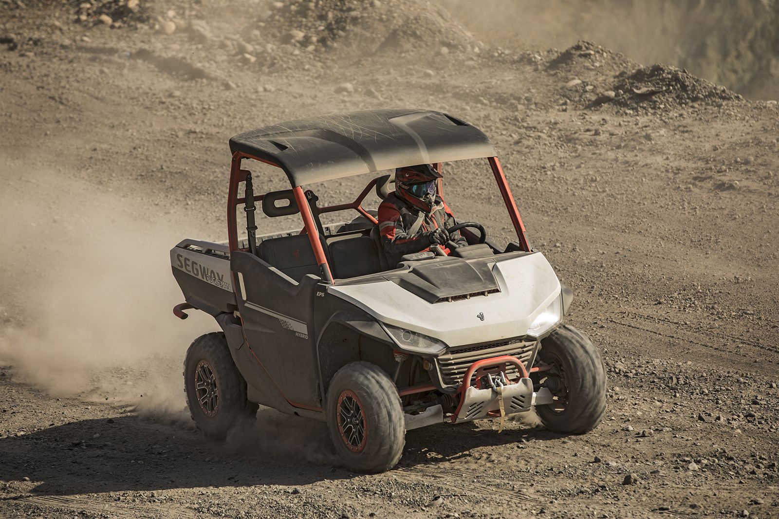 Utv Driving on A Dusty, Rocky Terrain. Driver Wearing a Helmet — Whitsunday Mowers In Cannonvale, QLD