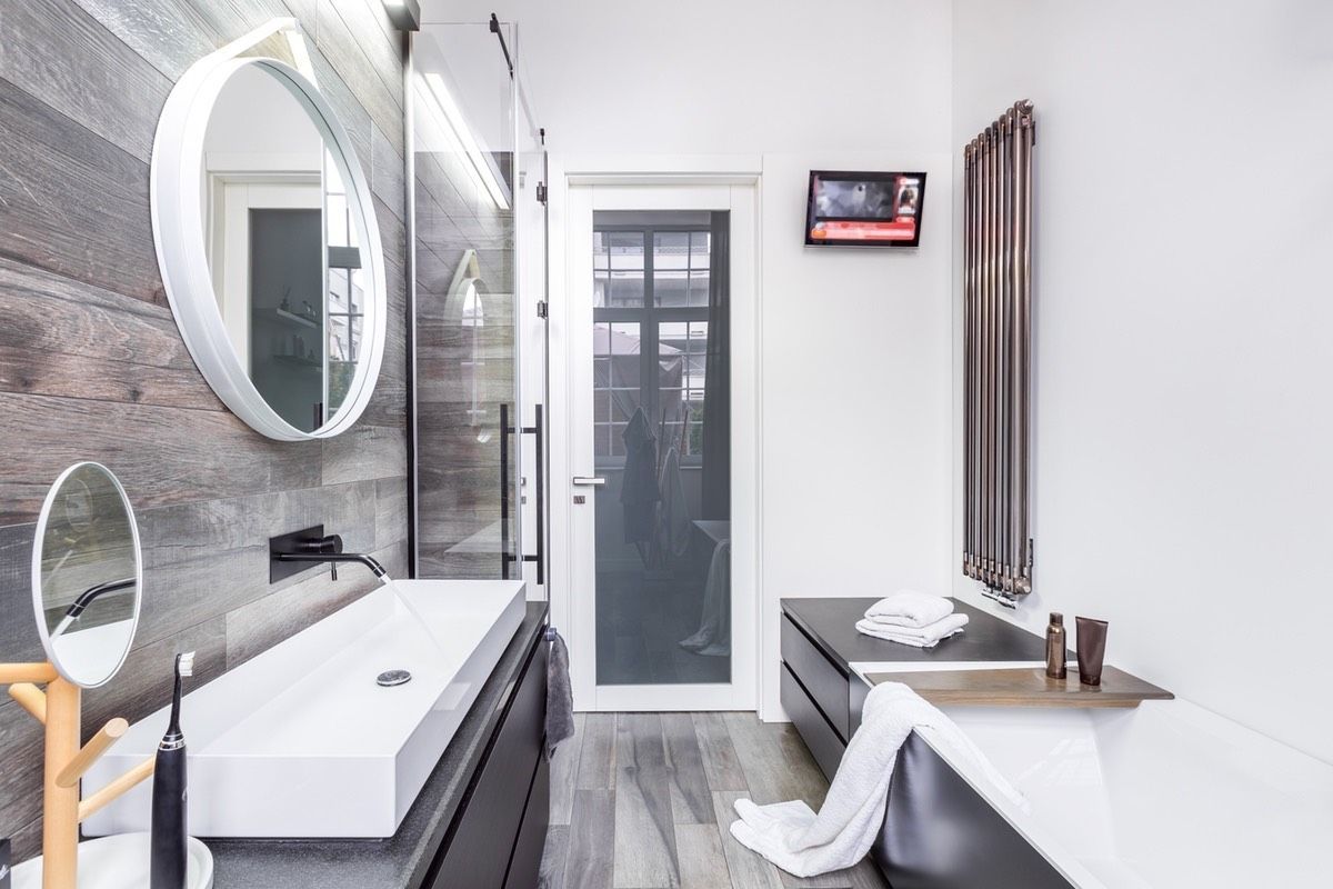 A bathroom with a sink , mirror , and bathtub. Design Services