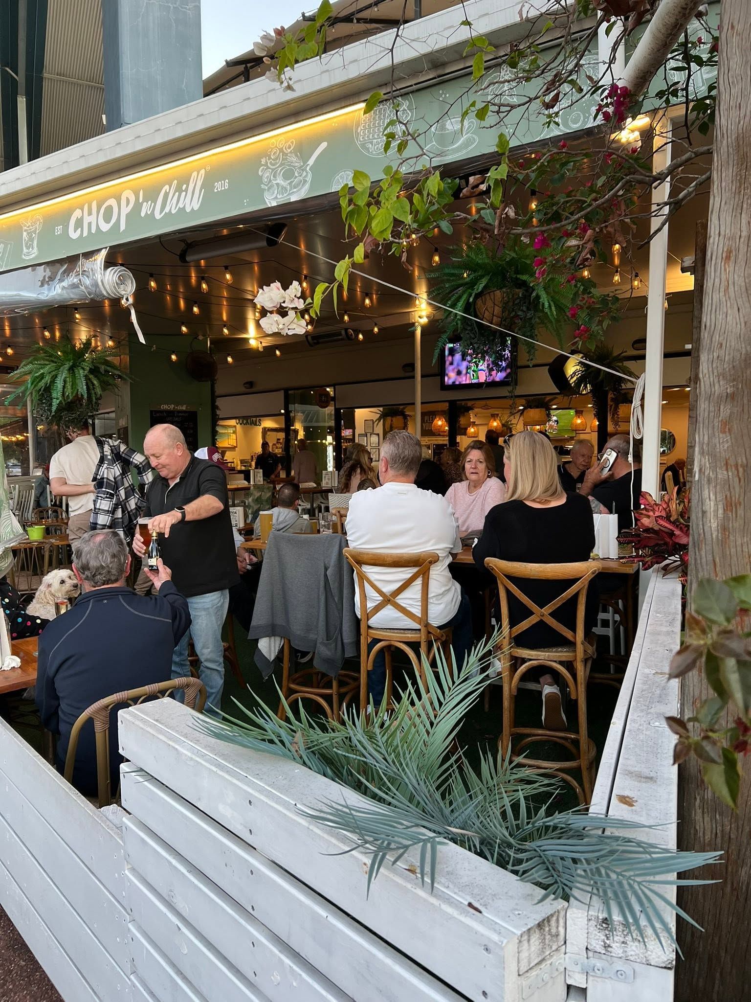 A Plate of Food With a Bottle of Wine and Two Glasses of Wine on a Table — Chop ‘n Chill Raby Bay in Cleveland, QLD