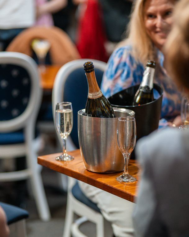 A Bottle of Wine is in a Bucket on a Table — Chop ‘n Chill Raby Bay in Cleveland, QLD
