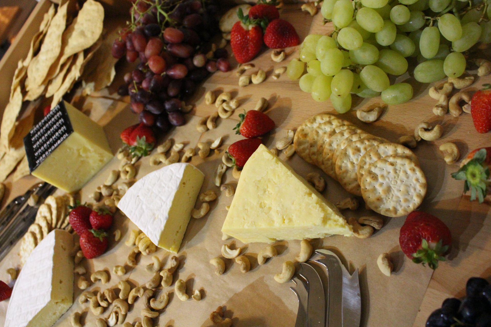 Wooden Cutting Board Topped With Cheese, Fruit, Nuts and Crackers — Chop ‘n Chill Raby Bay in Cleveland, QLD