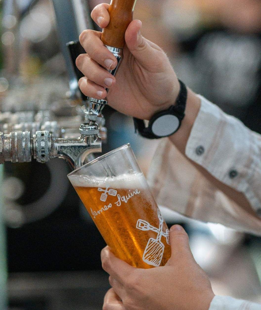 A Person is Pouring Beer Into a Glass From a Tap — Chop ‘n Chill Raby Bay in Cleveland, QLD