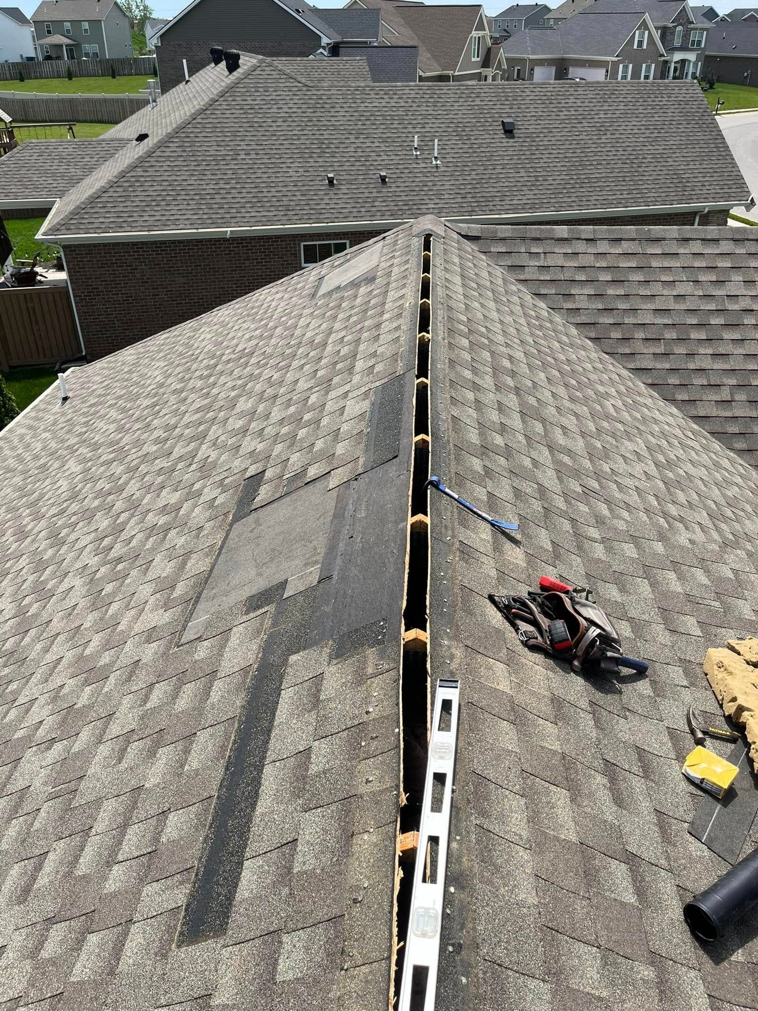 A roof with a ladder and a level on it.