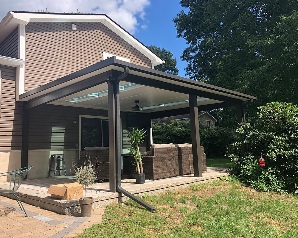 A house with a covered patio in front of it