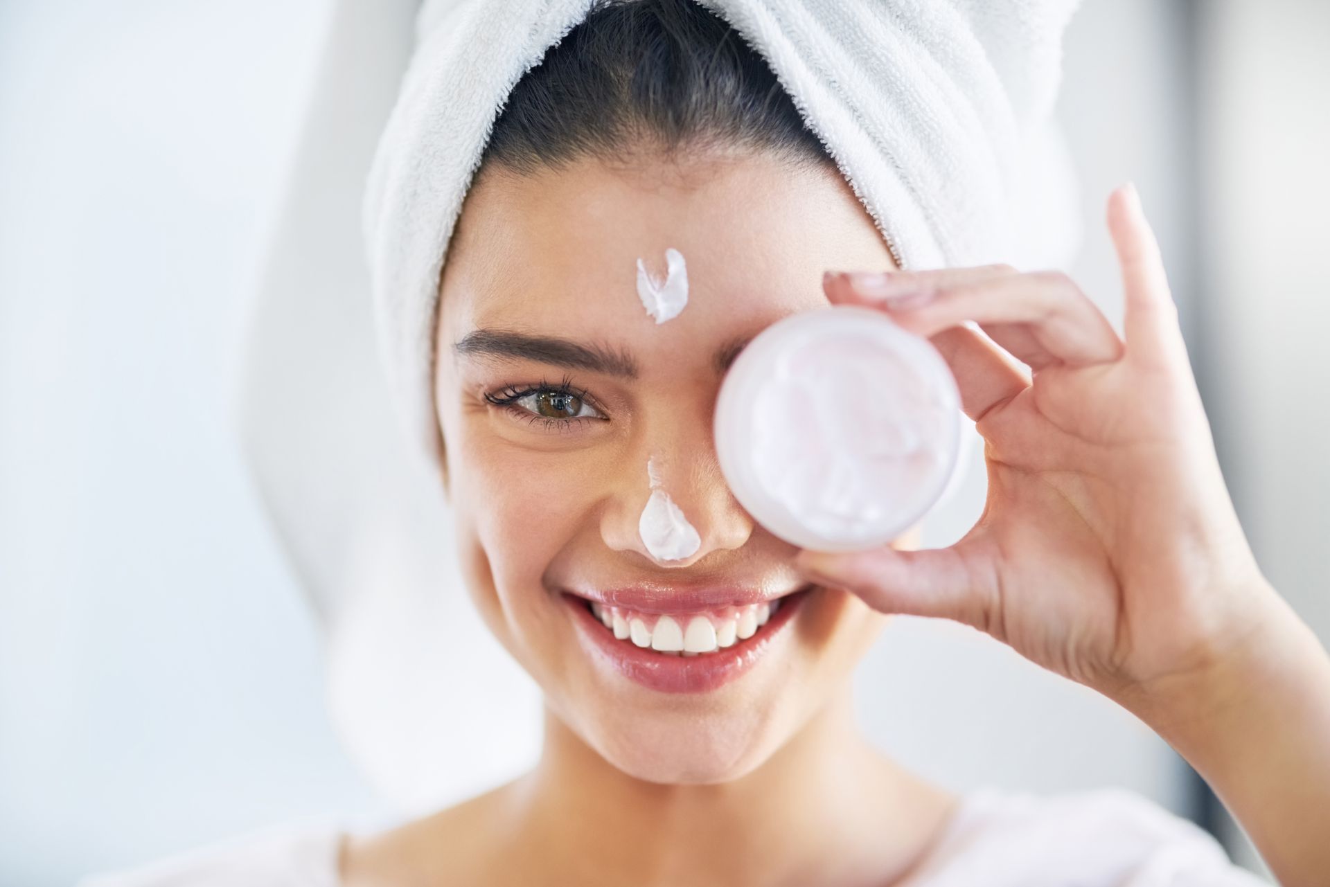 senior woman applying skincare product