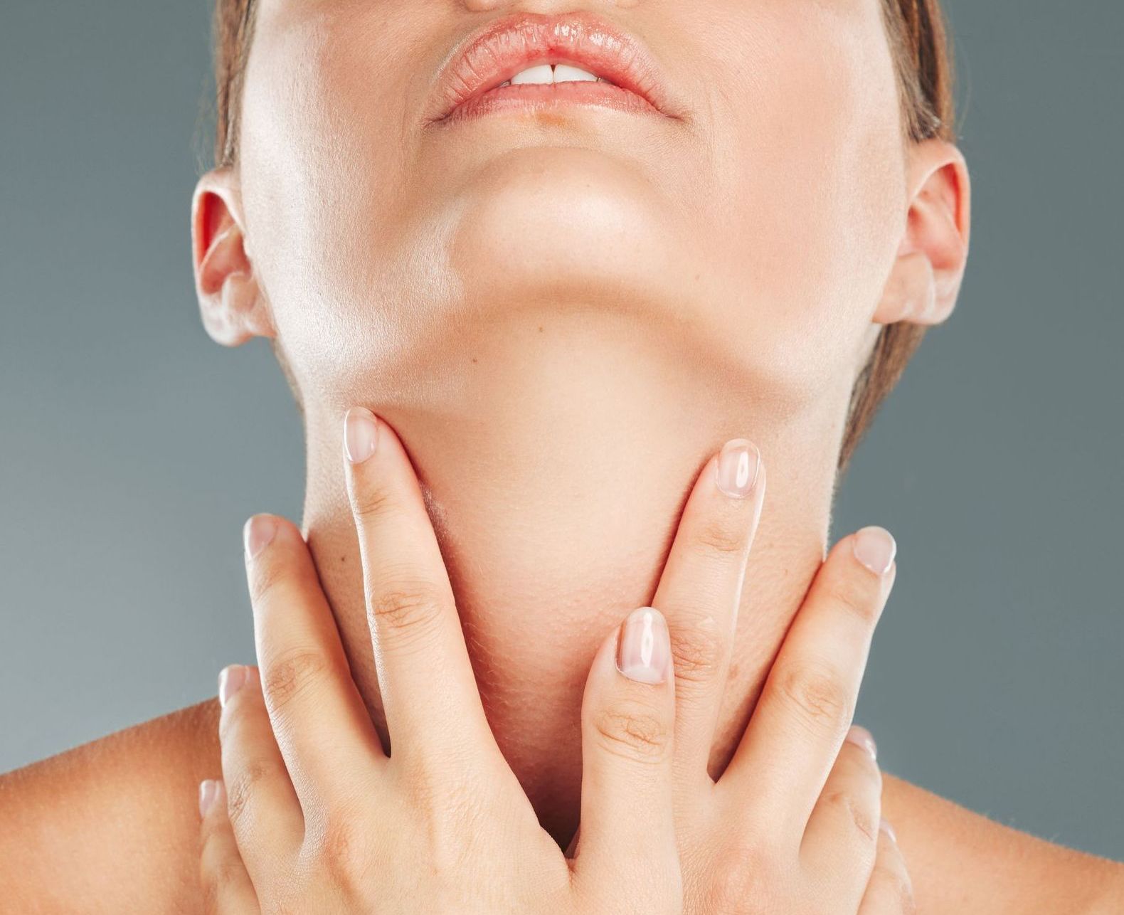 woman touching her neck closeup
