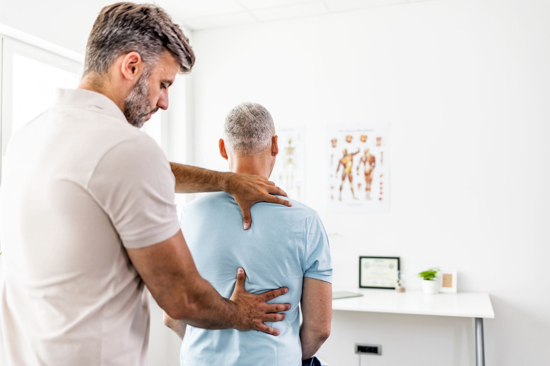 A man is getting a neck massage from a woman