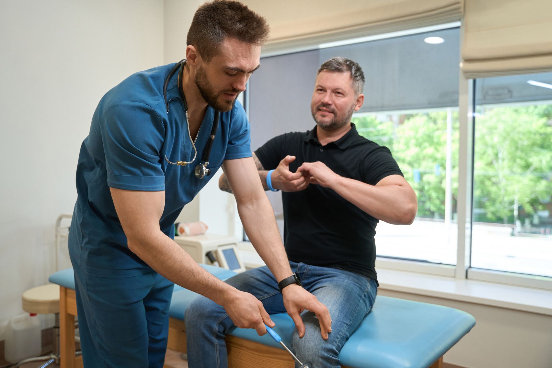 A doctor is examining a patient 's arm with a stethoscope