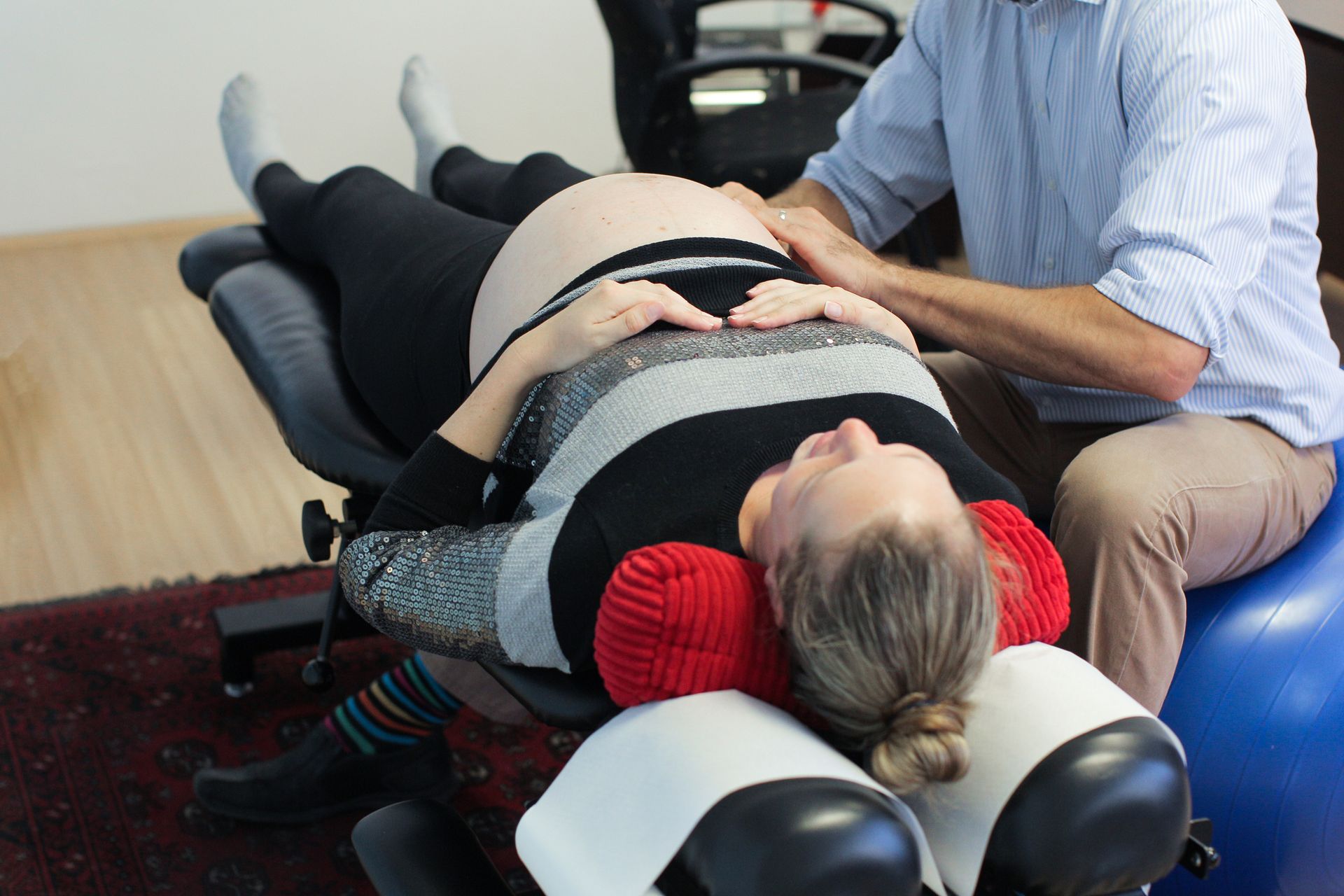 A man is getting a neck massage from a woman