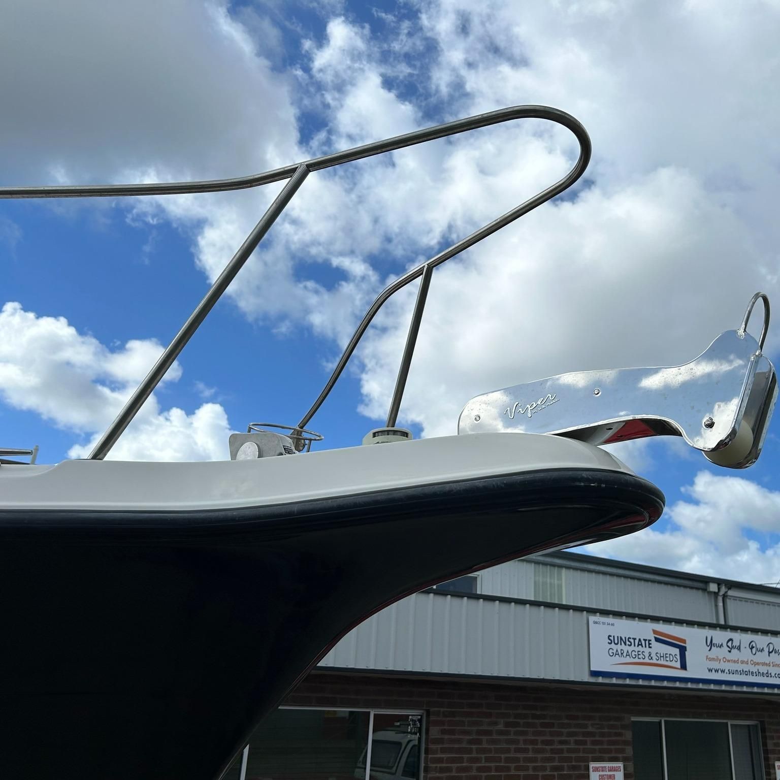 A Boat Is Parked In Front Of A Building — Murraycraft Fibreglass In Glenella, QLD