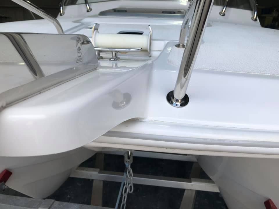 A White Boat With A Ladder Attached To It — Murraycraft Fibreglass In Glenella, QLD