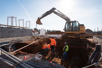 A group of construction workers are working on a construction site.