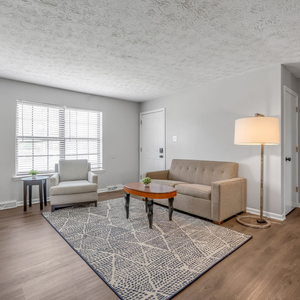 A man is looking at a blueprint on a table.
