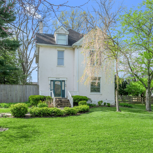 Two construction workers are standing next to each other on a construction site.