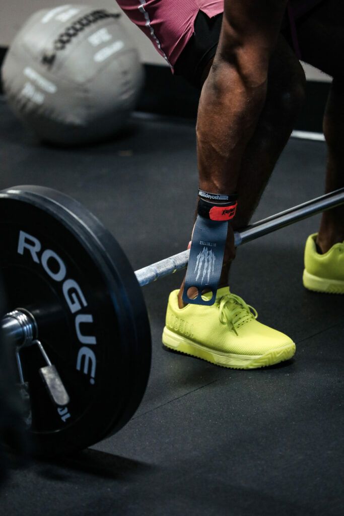 A person is lifting a barbell in a gym.