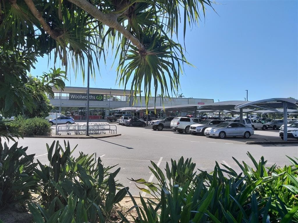 A Lot of Cars Are Parked in A Parking Lot in Front of A Building — Mission Beach Property Management in Wongaling Beach, QLD