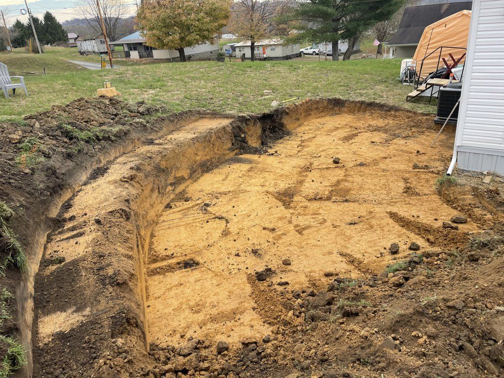 A large pile of dirt is sitting in front of a house.