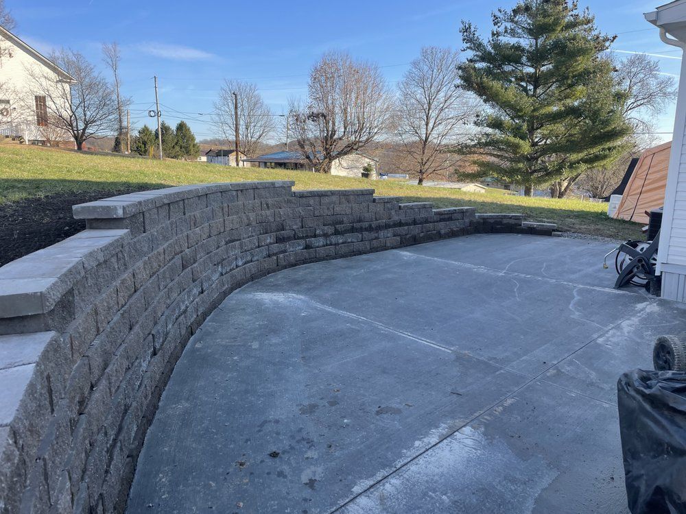 A brick wall is being built in front of a house.