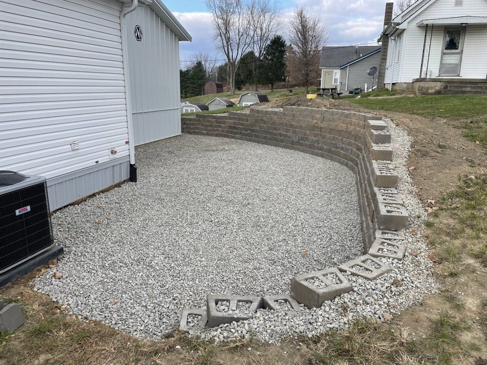 A concrete wall is being built in front of a house.