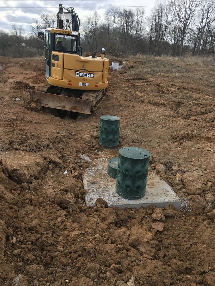 A bulldozer is sitting in the middle of a dirt field.