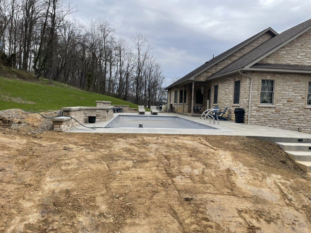A large house with a swimming pool in front of it.