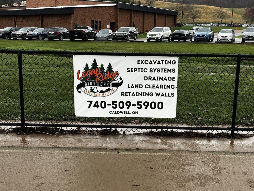 A sign that says excavating septic systems drainage land clearing and retaining walls