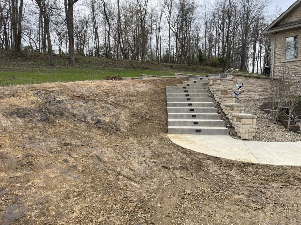 There are stairs leading up to a house in the background.