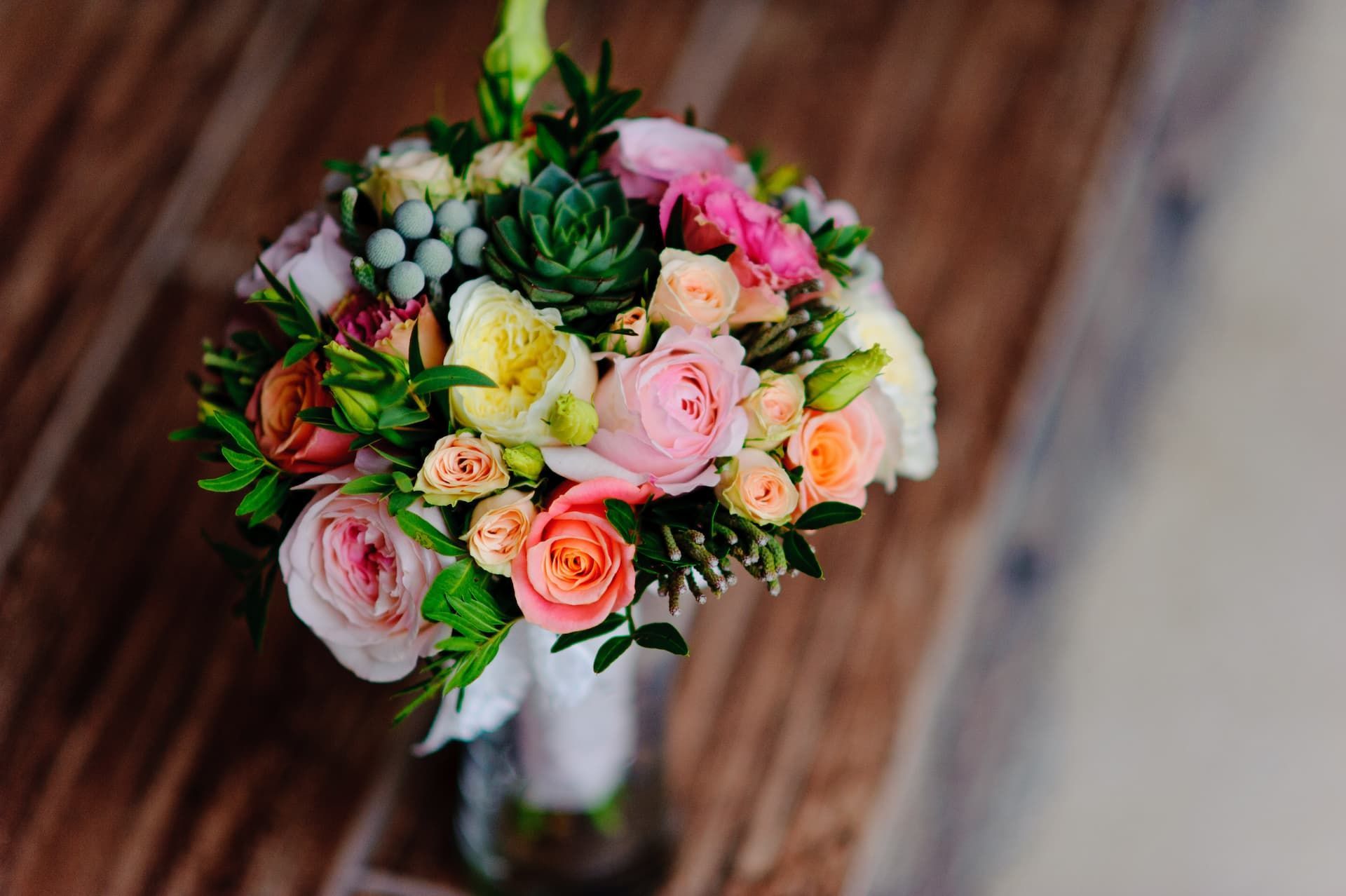 a bouquet of flowers is sitting on a wooden table