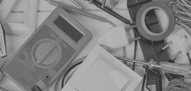 A black and white photo of electrical tools on a table - Electrician in Emerald | All Saints Electrical