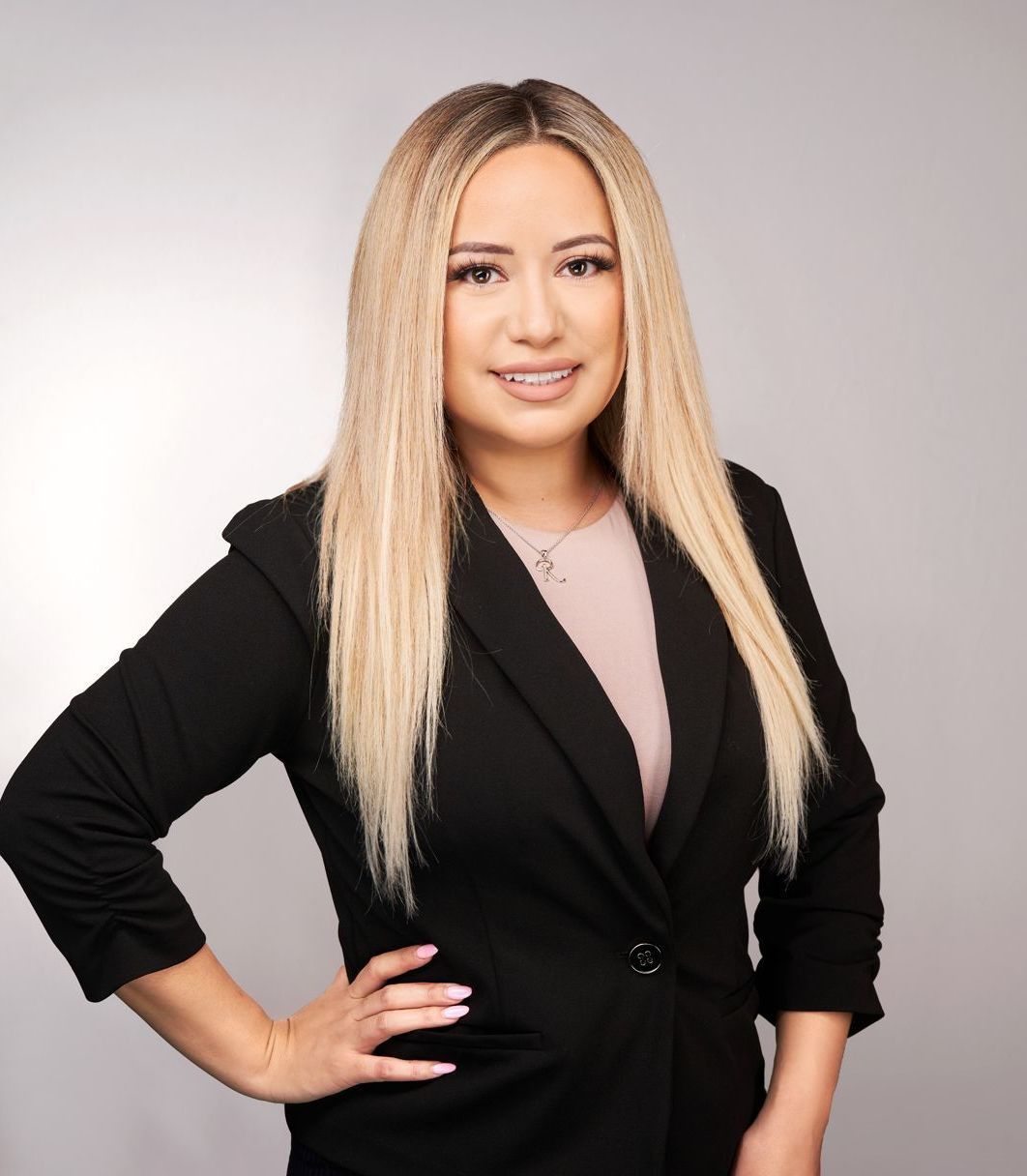 A woman in a black jacket is posing for a picture.