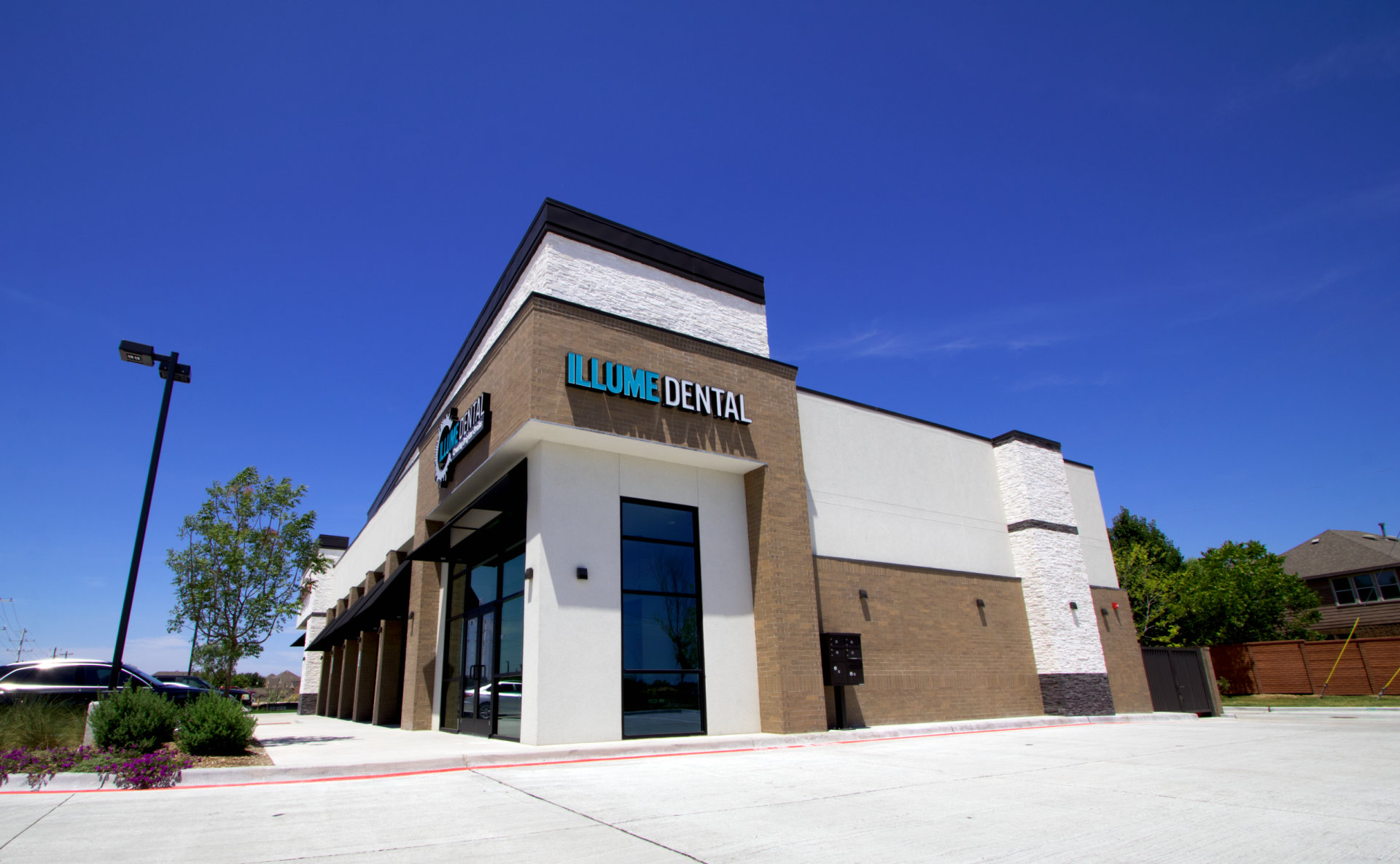 A dental office with a blue sign that says luxe dental