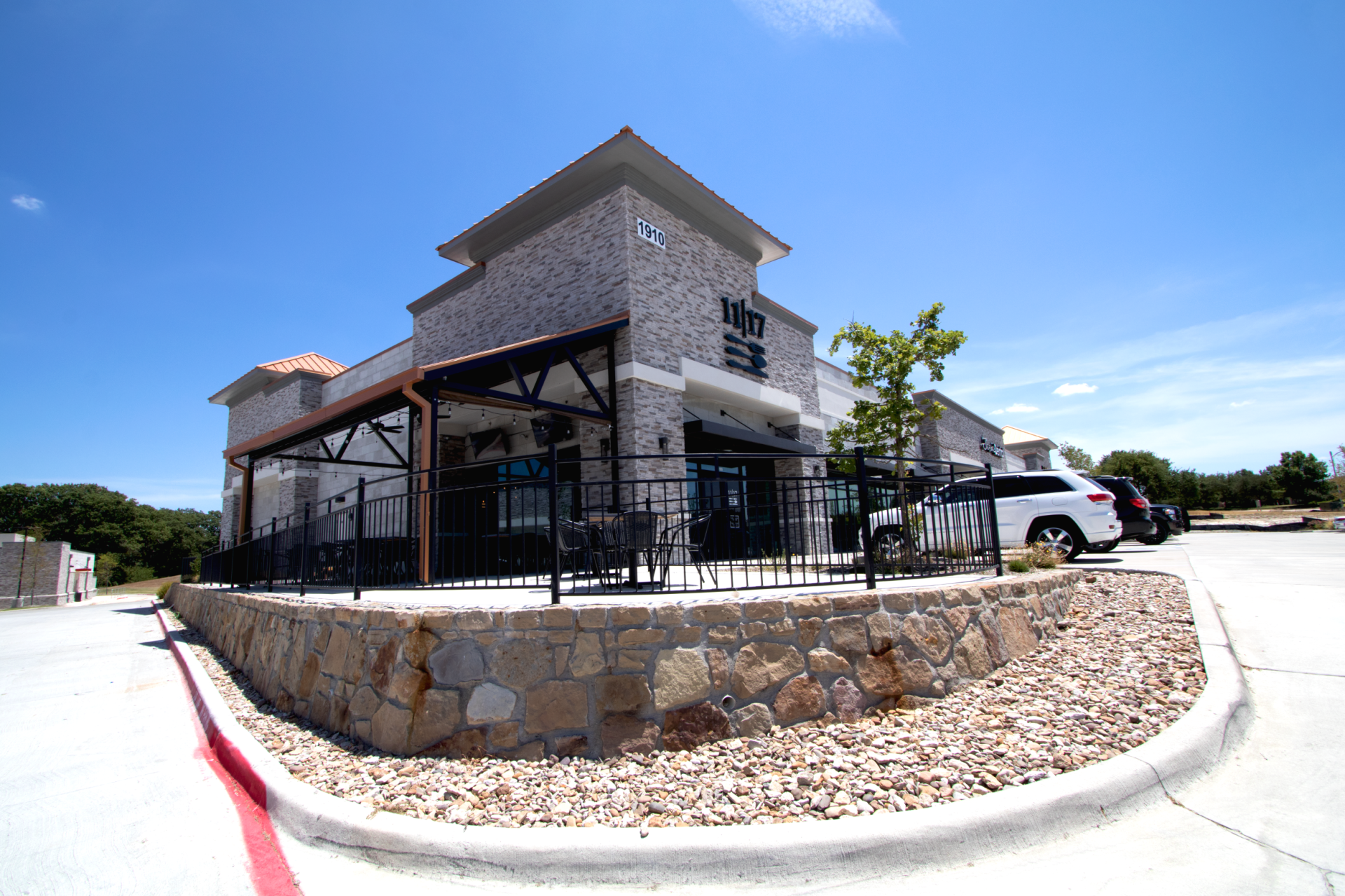 A large building with a lot of cars parked in front of it