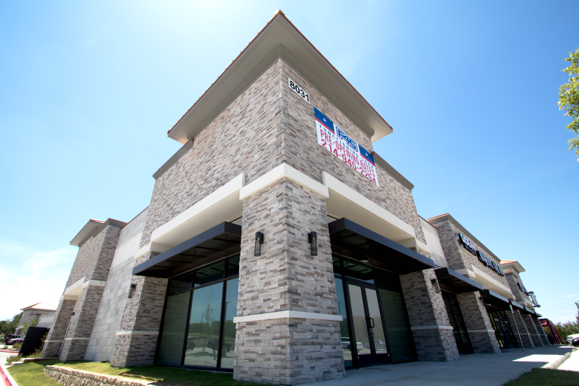 A large brick building with a sign that says ' for sale ' on it