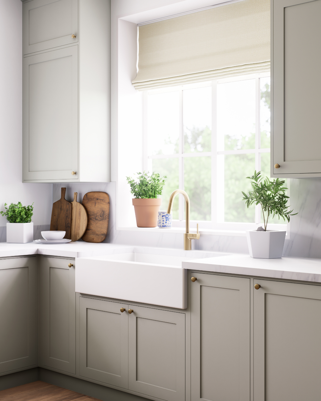 A kitchen with white cabinets , a sink and a window.