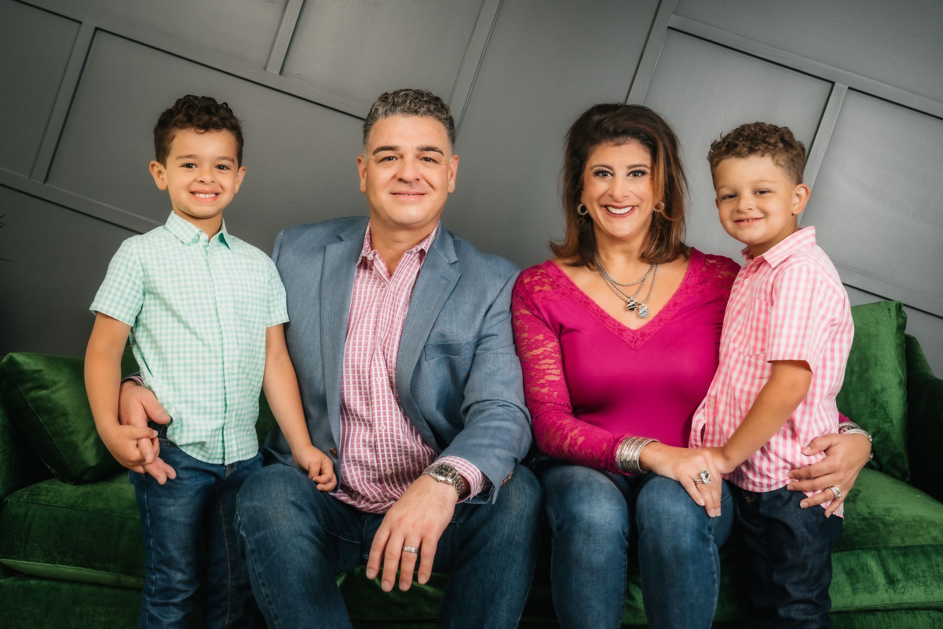 A man in a suit and tie with a red rose in his lapel.