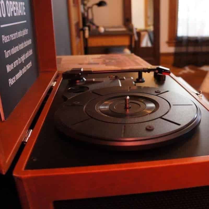 A record player with a sign that says to operate