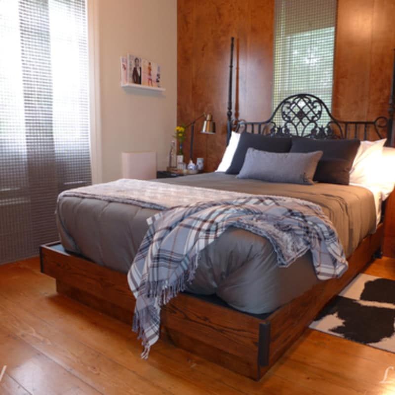 A bed with a blanket on it in a bedroom