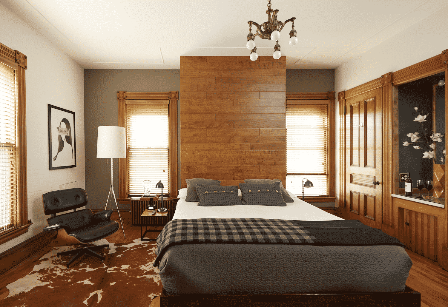 A bedroom with a large bed and a chair