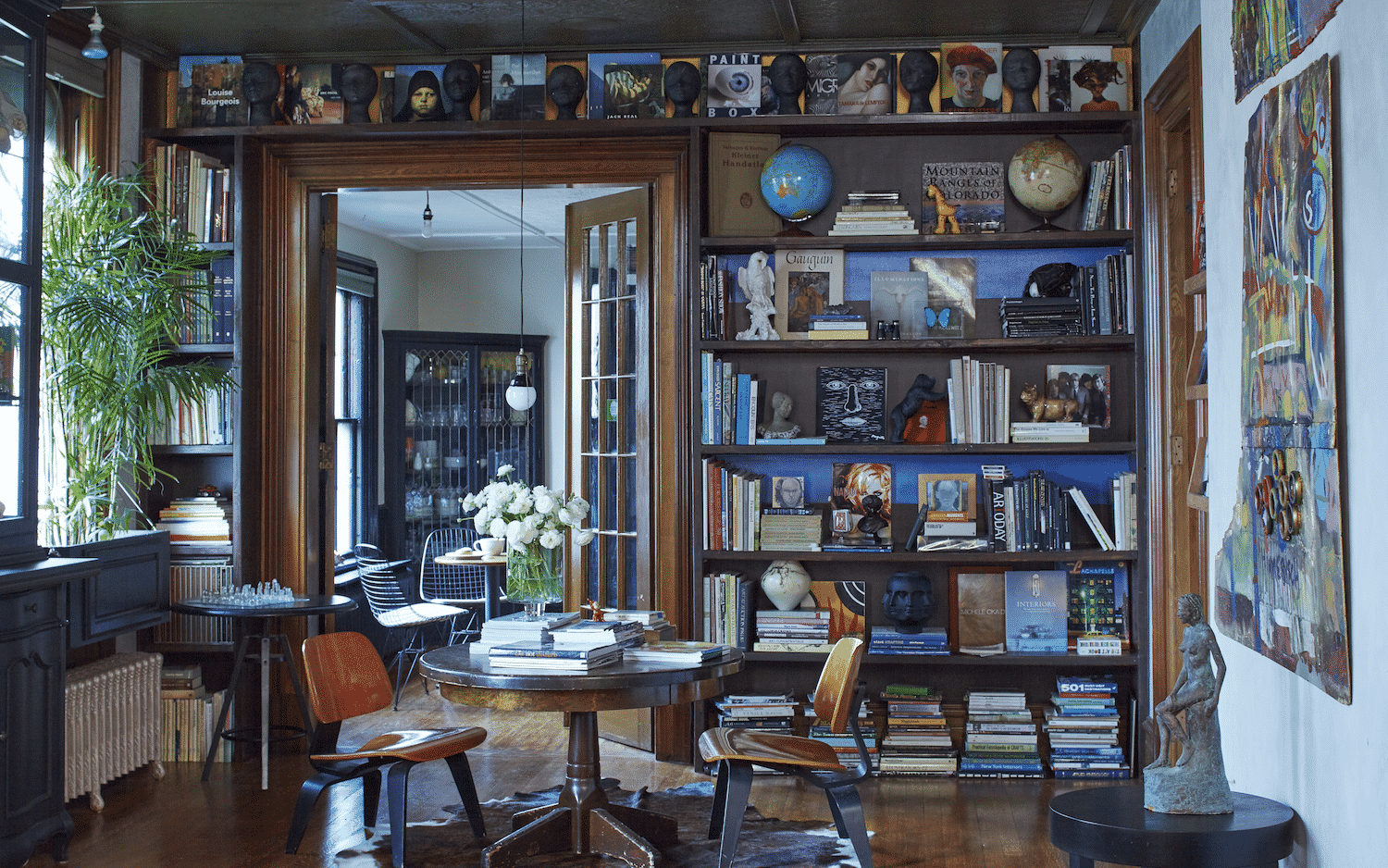A living room filled with furniture and bookshelves.