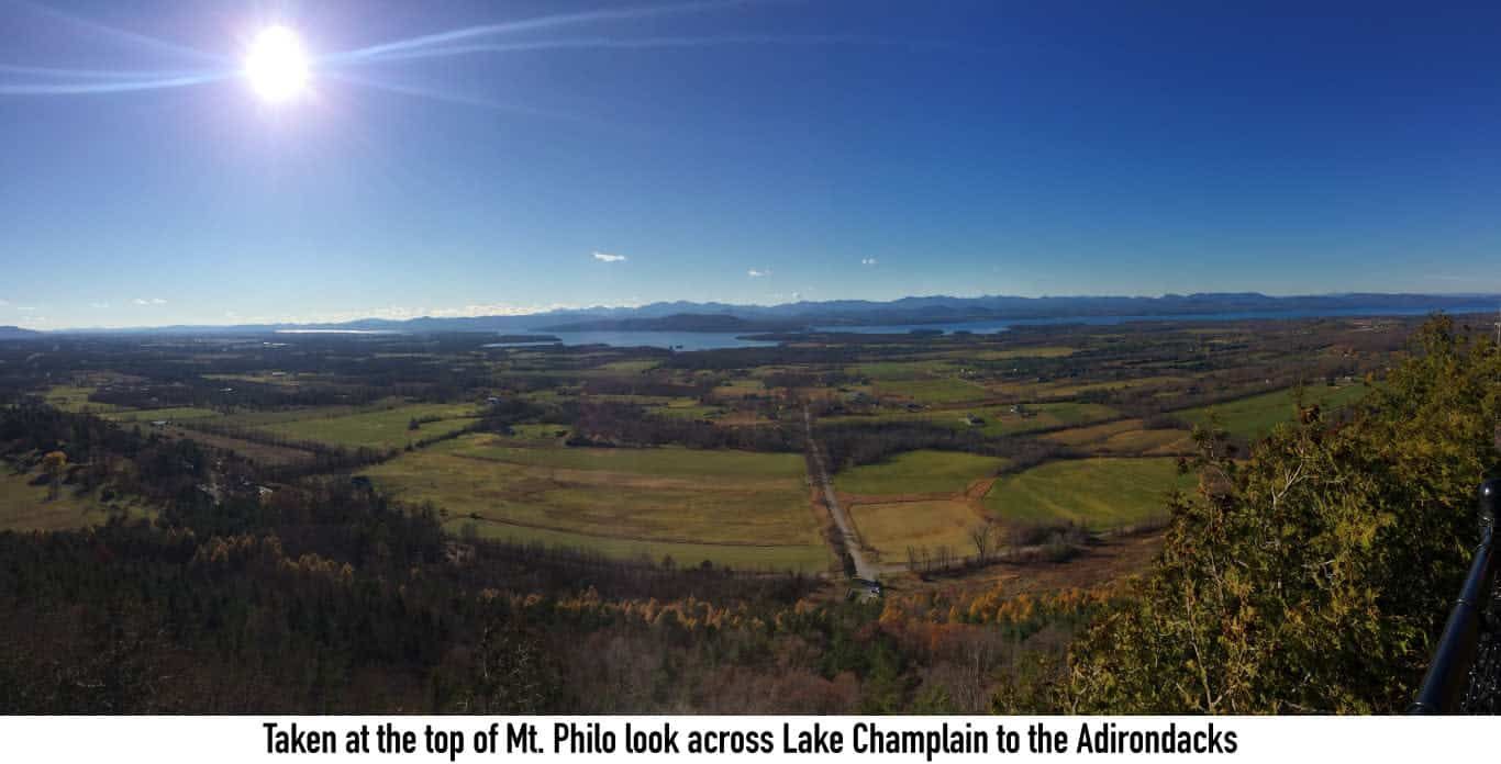 A panoramic view of a valley with mountains in the background