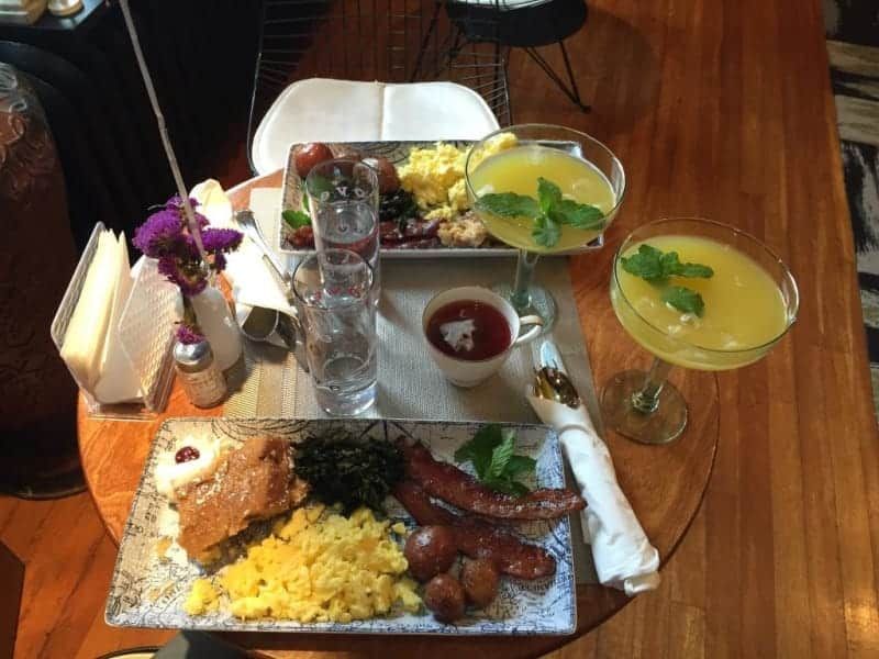 A table with plates of food and drinks on it