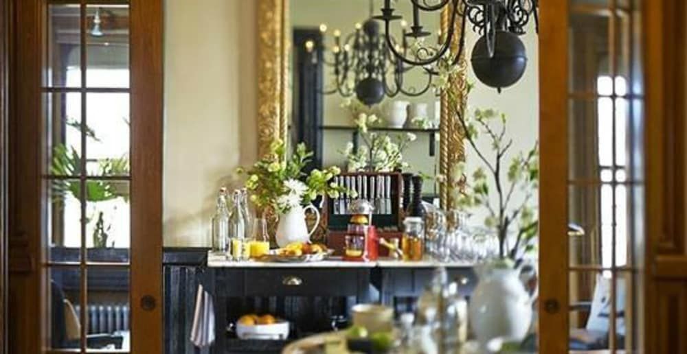 A dining room with a table and a mirror