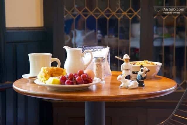 A table with plates of food and a cow figurine on it