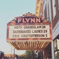 The flynn theater has a sign that says moth grandslam 28 barenaked ladies 29 and kris kristofferson 5.